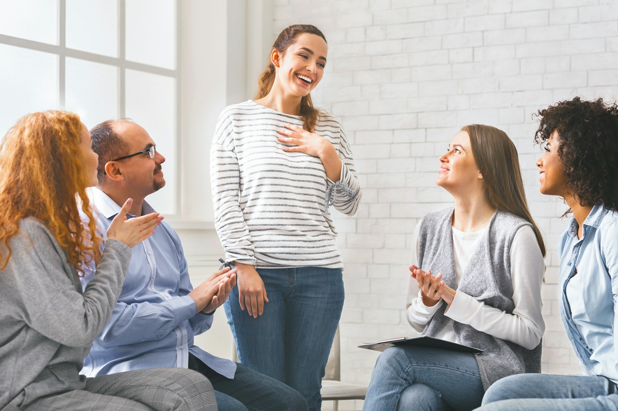 Happy welcoming woman at support group meeting,